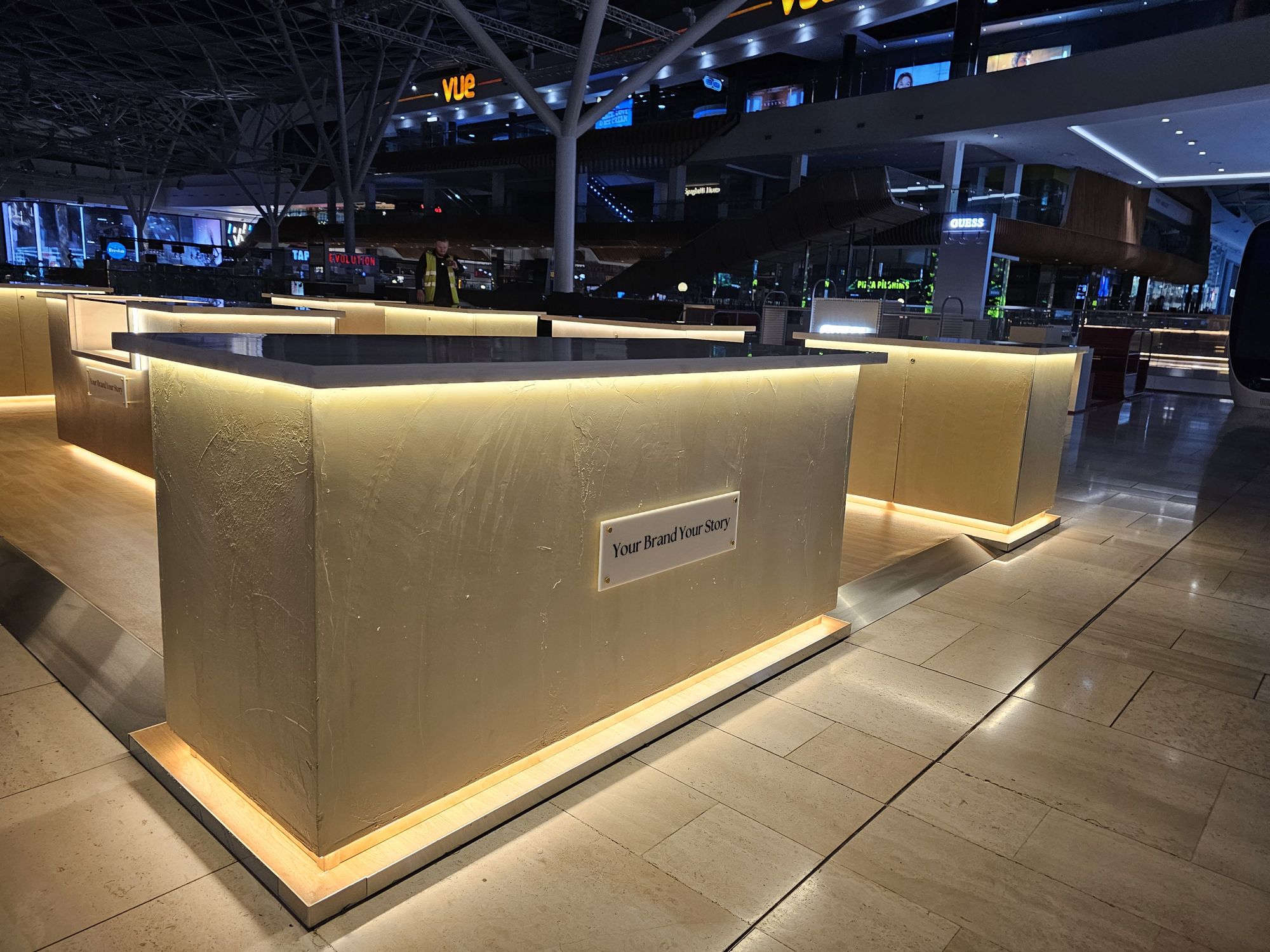 Your Brand Your Story brass effect illuminated display counter at Westfield White City by OLLYWOOD