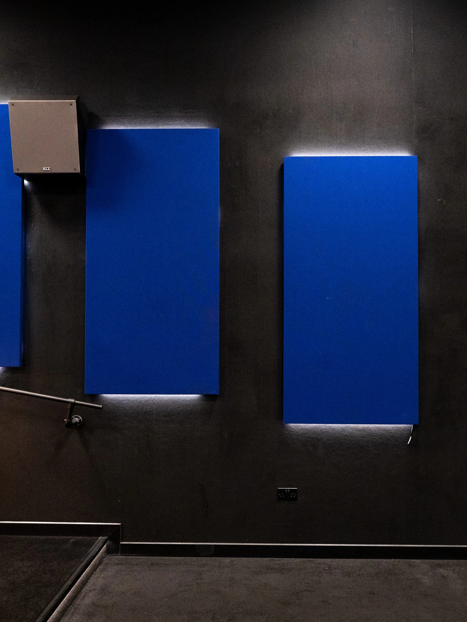 Blue fabric acoustic panels and integrated light strips at Gelert