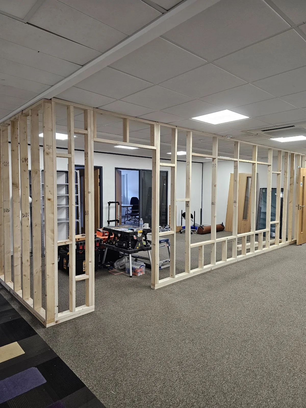 OLLYWOOD team building office partition walls on a Cardiff fit-out