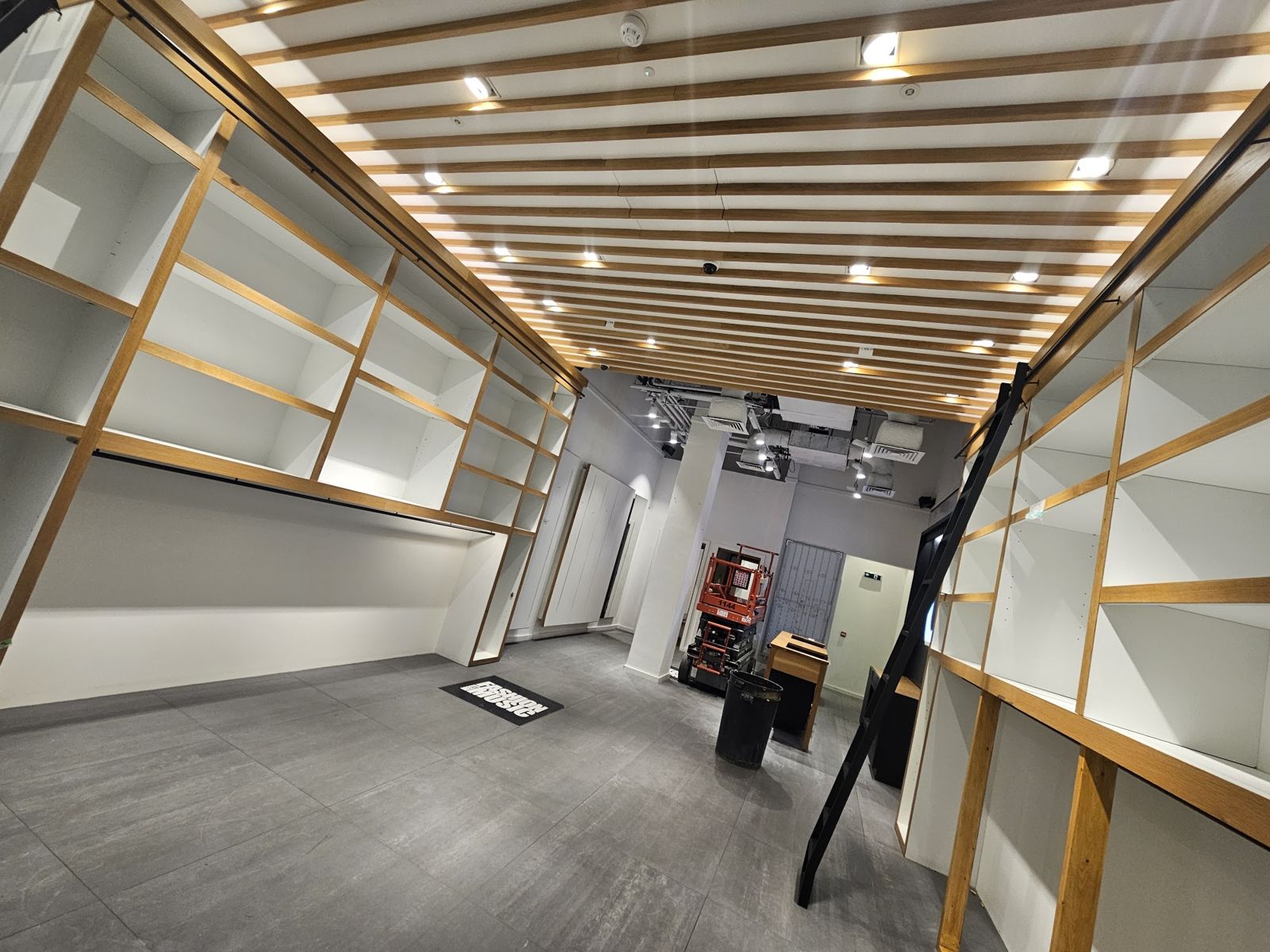 Retail kiosk shelving and slatted ceiling being installed overnight