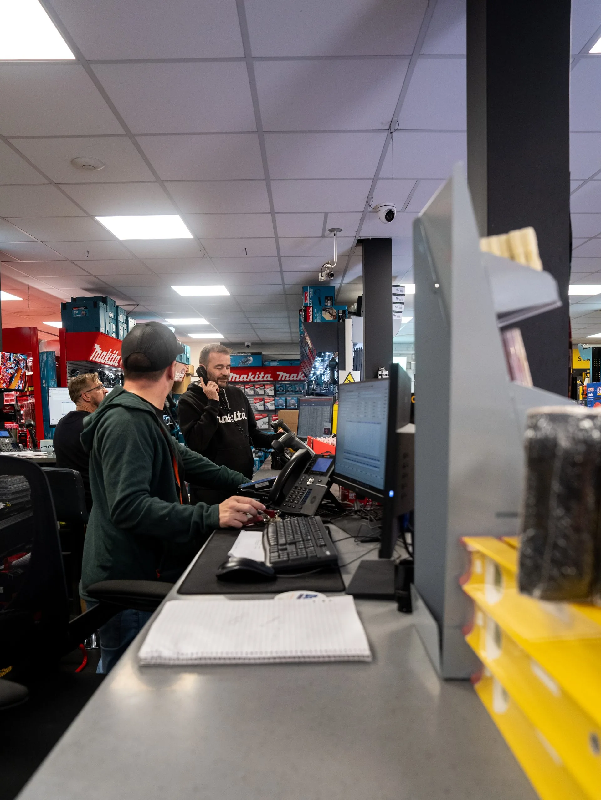 Staff side of the Data Power Tools counter with screens and customer service positions