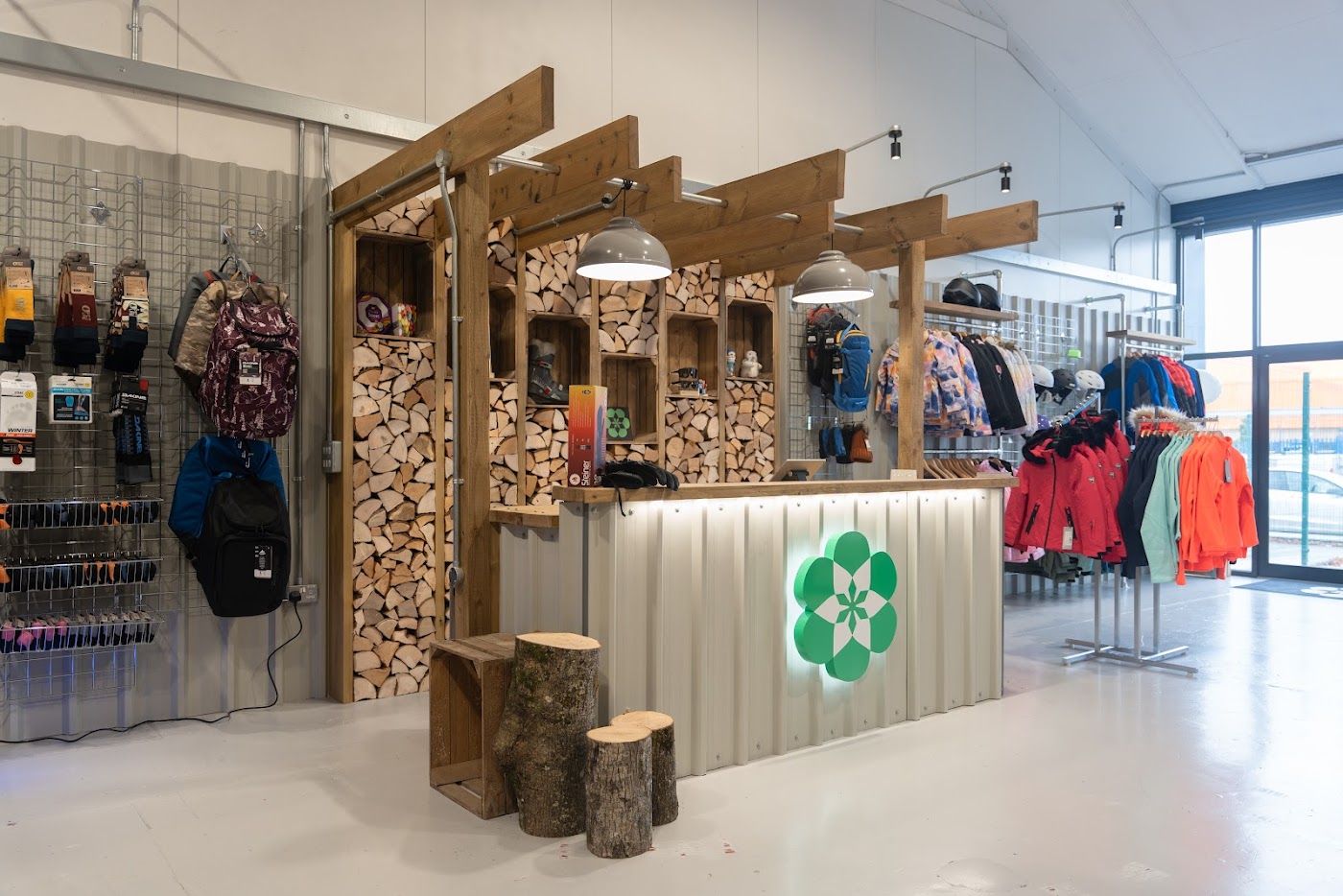 Naski retail fit-out in Cardiff with log wall and bespoke counter by OLLYWOOD