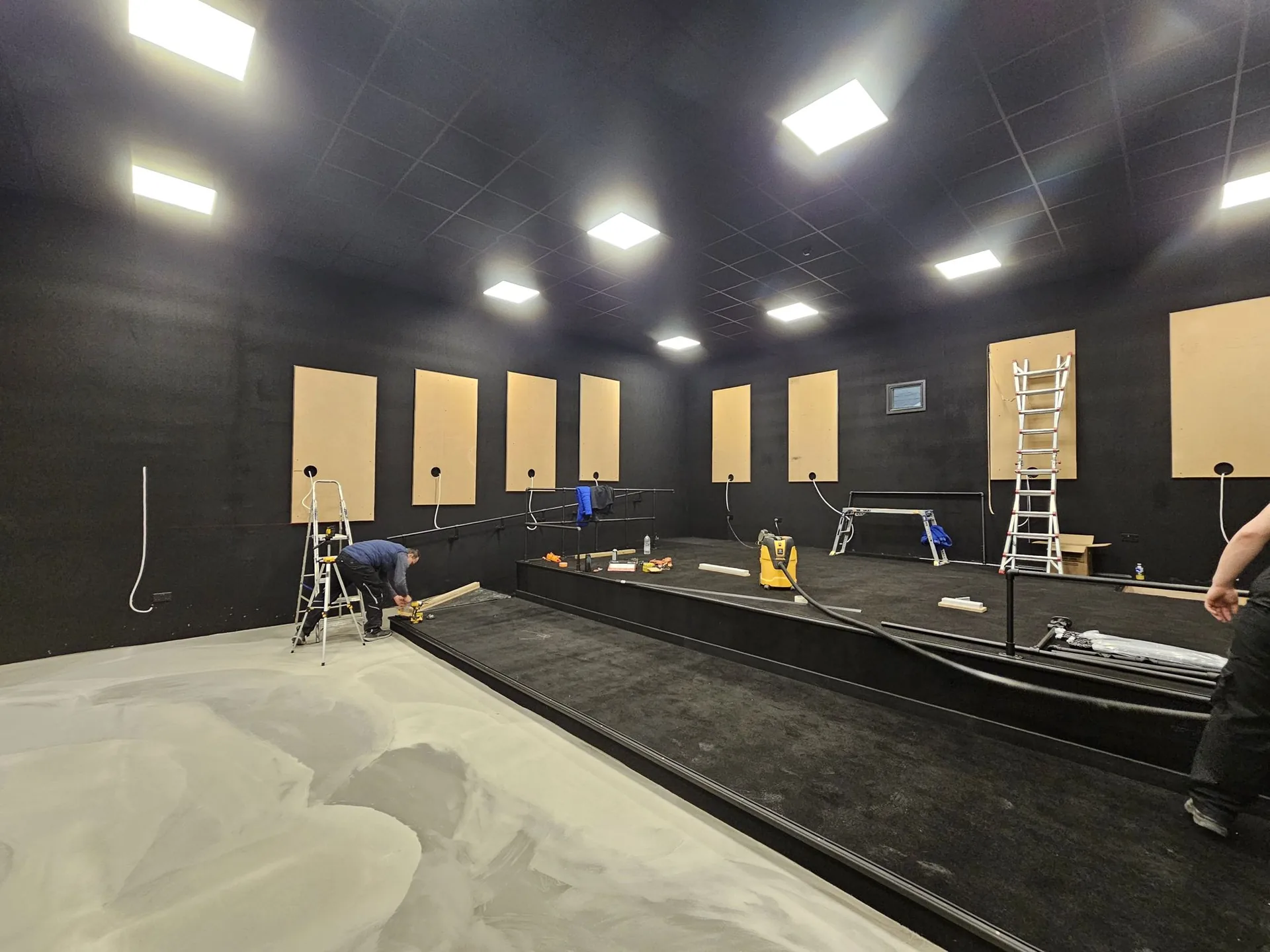 OLLYWOOD team installing acoustic wall panels inside the Gelert post production studio