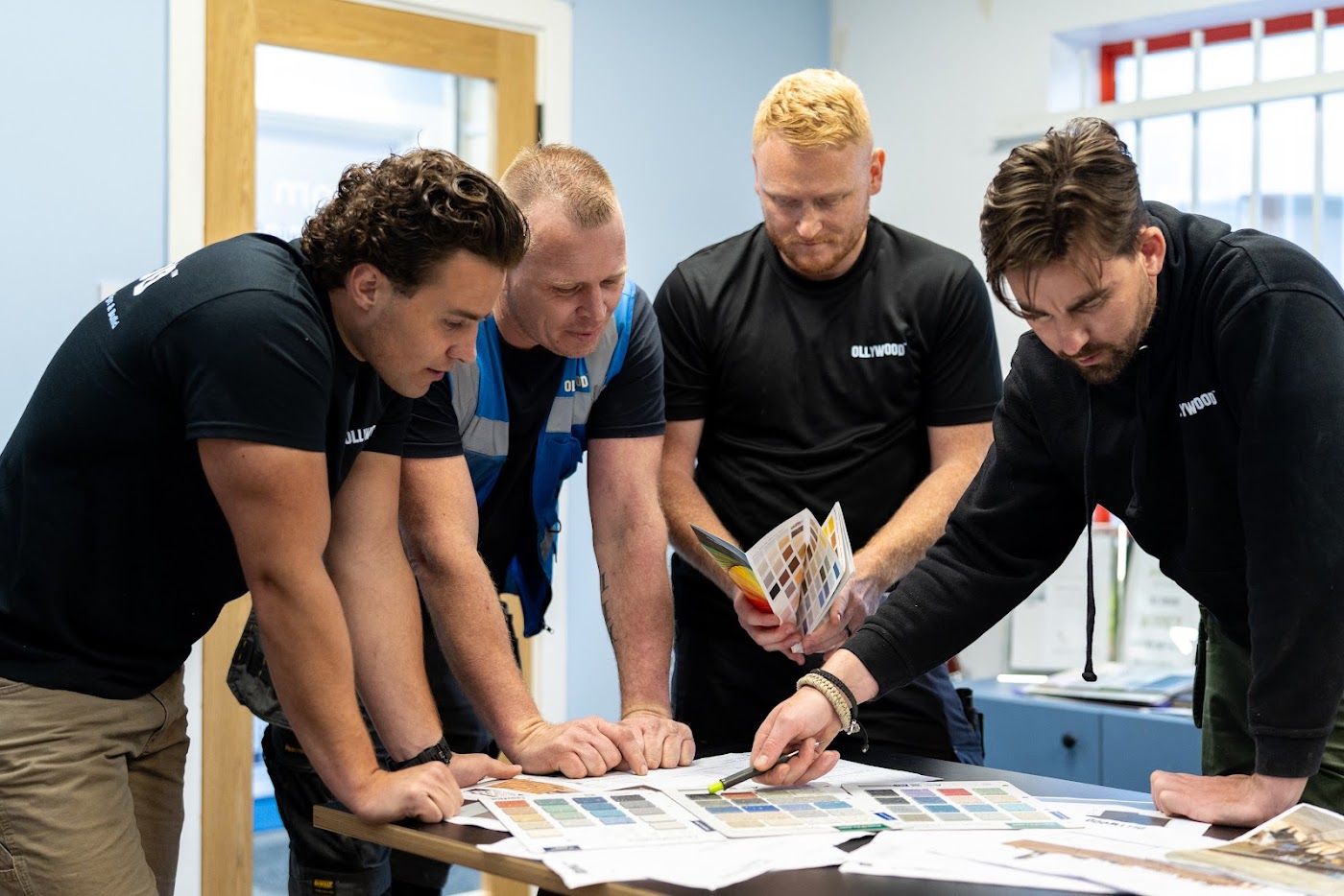OLLYWOOD team reviewing material samples and drawings in Cardiff