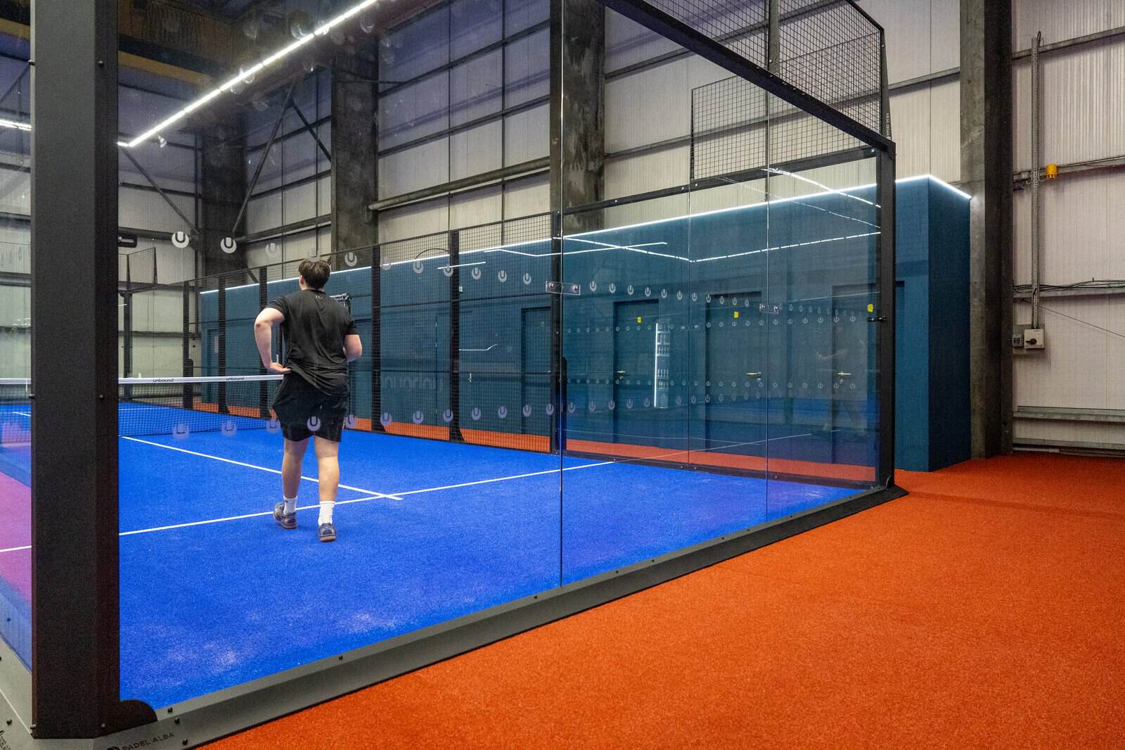 Unbound Padel singles court glass wall Llantrisant — built by OLLYWOOD with Padel Alba