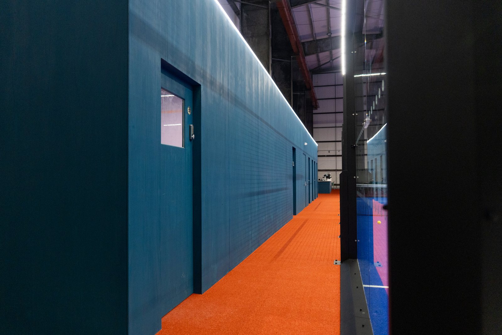 Unbound Padel bespoke room run with halo lighting and Danish blue oil finish
